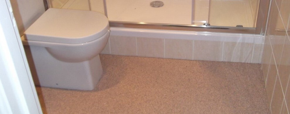 Internal flooring of a bathroom - showing the high quality resin product around a toilet.